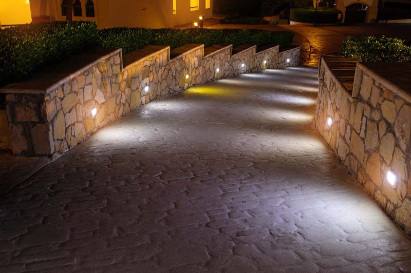 Image of a well-lit pathway at dusk, featuring Electrician Flowermound and highlighting Landscape Lighting, ensuring it aligns with the page's context.