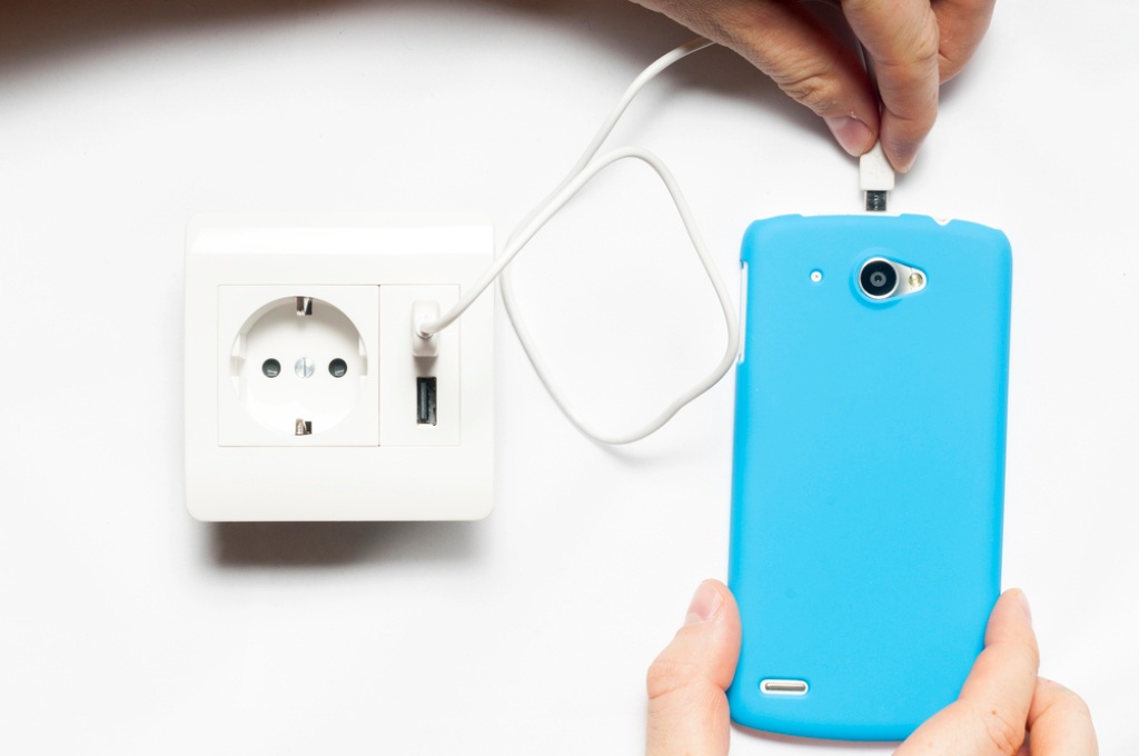 Image of a wall socket with two USB charger ports, featuring Anderson Lighting & Electric and highlighting the electrical services offered on their website.
